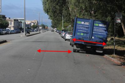 Red arrows show width of truck and remaining width in lane, both about 8 feet across