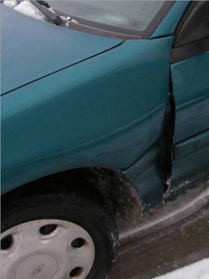 Escort - damaged driver's side front fender and door