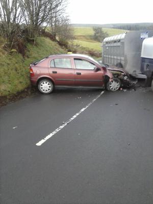 Red car (mine) and trailer of other vehicle showing. The position of the back of the trailer is the position the vehicle and trailer were traveling in when we hit.